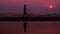 Silhouette. lonely asian young man walking peacefully along a deserted beach at sunset. seascape