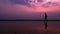 Silhouette. lonely asian young man walking peacefully along a deserted beach at sunset. seascape