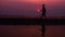 Silhouette. Lonely Asian young man walking peacefully along a deserted beach at sunset. Seascape