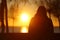 Silhouette of a lonely woman watching sunset in winter