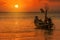 Silhouette longtail boat fishingboat moored on tropical beach  at fisherman village during sunset twilight time