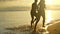 Silhouette love couple running together on the beach with sunset view. Romantic and relaxing on summer