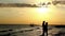 Silhouette Of A Loving Couple on the Beach At Sunset Embrace and Kiss