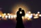 Silhouette of loving couple on bokeh lights background