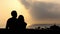 Silhouette Of A Loving Couple Dancing and Hugging Near the Sea at Sunset