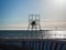 Silhouette of a loving couple on a lifeguard tower on the beach