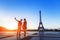 Silhouette of a loving couple taking selfie portrait photo in front of Eiffel Tower, Trocadero, Paris, France
