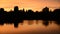 Silhouette of the Main Temple Buildings with Lake Reflection at Sunrise - Angkor Wat, Cambodia