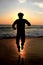 Silhouette male adult jumping at a beach