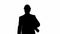 Silhouette Male architect in a suit and hard hat walking with bl
