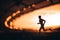 Silhouette of a Male Athlete, an Endurance Runner, Emerges Strong against the Blurred Background of a Modern Sports Stadium