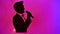 Silhouette of a male classical singer singing with a microphone in the studio,