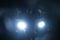 a silhouette of a male criminal suspect with hands up during night pursuit in front of the police car headlights