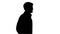 Silhouette Male doctor in white coat walking with hands in pocke