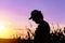 Silhouette of male farmer standing on cornfield