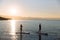 Silhouette of male and female on sup surf swimming at the ocean. Concept lifestyle, sport, love