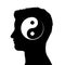 Silhouette of male head with yin yang symbol