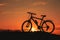 Silhouette of a male mountainbiker at sunset in the mountains