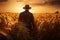 Silhouette of Man agronomist farmer in golden wheat field, The concept of harvesting in agriculture. A farmer walks through a