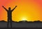 Silhouette of man with arms up with cheerful on golden sunrise background, successful life concept