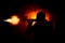 Silhouette of man with assault rifle ready to attack on dark toned foggy background or dangerous bandit in black wearing balaclava