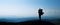 Silhouette of man with baby son in mountainous areas.