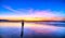 Silhouette of man on the beach looking at magical dramatic sunrise