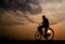 Silhouette of a man on bicycle on twilight time