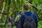 Silhouette of a man with a blue rain coat deep in the Amazonian Jungle, in Cuyabeno National Park, South America Ecuador