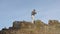 Silhouette of man boxing with shadow on the rock at sunset. Strong muscular boxer. Shadow fight on the rock rear view