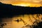 Silhouette of a man in a canoe at sunset