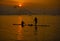 Silhouette of a man crawling fish in beautiful sunset of Jati Luhur Dam, Purwakarta, West Java, Indonesia.