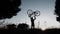 Silhouette of man cyclist lifts the bicycle as a symbol of victory during a sunset.