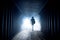 Silhouette of a man in a dark hazy underground corridor