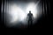 Silhouette of a man in a dark hazy underground tunnel