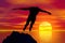 Silhouette of a man diving on sunset