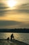 Silhouette of man on dock of shimmering lake