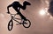 Silhouette of a man doing an BMX extreme jump.