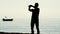 Silhouette of man doing morning exercises on sea beach