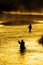 Silhouette of Man Flyfishing Fishing in River Golden Sunlight