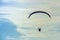 Silhouette man flying with paramotor in the blue sky