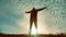 Silhouette of a man with hands raised in the sunset concept for religion, worship, prayer and praise. silhouette of a