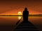 silhouette of a man in a hat rowing a small boat with the sun in the background