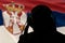 Silhouette of a man in headphones on the background of the flag of Serbia, eavesdropping conversation, secret agent, spy and scout