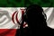 Silhouette of a man in headphones, secret agent eavesdropping, spy and scout, flag of Iran, backlight