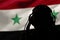 Silhouette of a man in headphones, secret agent eavesdropping, spy and scout, Syria flag, backlight