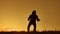 Silhouette of a man in a hood with a knife. Shadow blur of horror man in jacket with hood facing side lifestyle body and