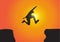 Silhouette of man jumping over the cliffs on golden sunrise background, achievement, success and winning concept