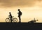 Silhouette man and kid with bicycle outdoor sport activity Take care Family concept