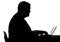 Silhouette of a man lead inactive lifestyle, working on laptop